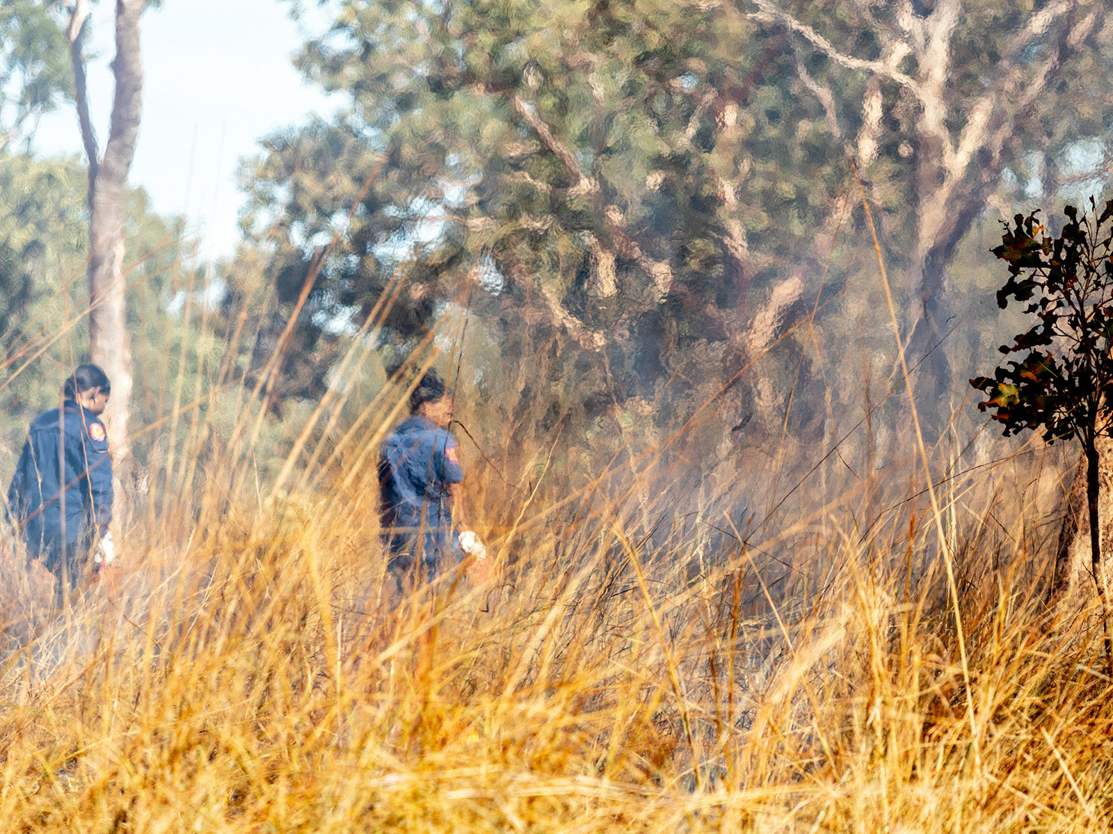 Mimal Rangers Kaitlin John, left, and Josephine Austral, right, head out on Country to begin their dry season burning for the day. Photo: Renae Saxby